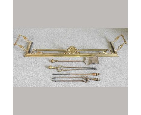 A 19th century brass fender, 169cm wide, together with various fire tools