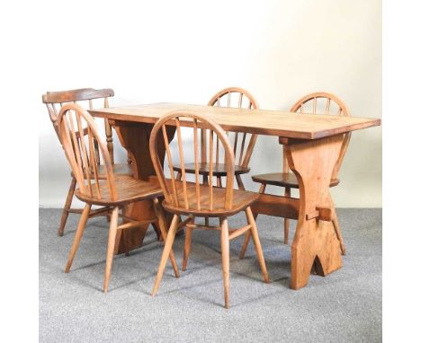 An early 20th century light oak refectory table, together with a set of four light elm Ercol dining chairs and an elm seated 