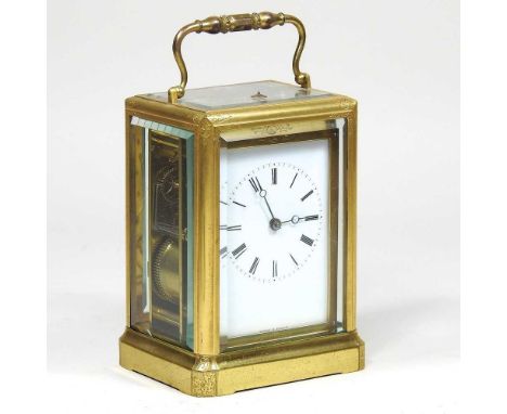 A 19th century French gilt brass cased repeating carriage clock, the chased case, with bevelled glass panels, the white ename