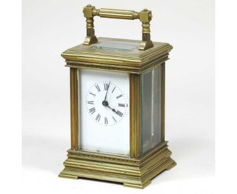A brass cased carriage clock, with a white enamel dial and lever platform escapement, 15cm high