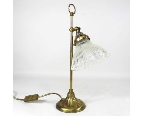A brass adjustable desk lamp, with a frilled glass shade, 41cm high