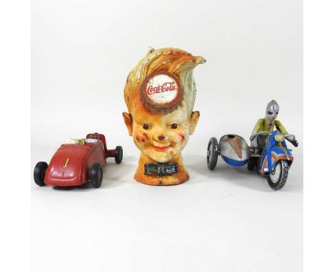 A cast iron Coca-Cola advertising money box, 20cm high, together with a tinplate toy motorcycle and a toy car (3)