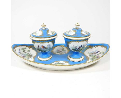 A 19th century Sevres style porcelain desk stand, of navette shape, with two inkwells, reserved with panels of exotic birds, 