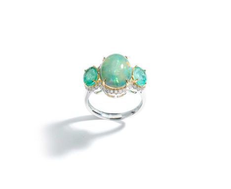 The oval cabochon opal between oval-cut emeralds, within a brilliant-cut diamond surroundRing size: M½