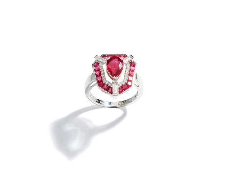 The pear-shaped ruby, weighing 1.40 carats, held by three baguette-cut diamond-set claws, within an openwork geometric surrou