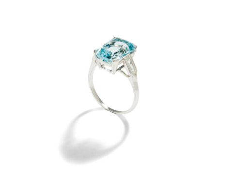 The rectangular scissor-cut aquamarine, between bullet-shaped diamond single-stone shoulders, mounted in platinum, Swedish as