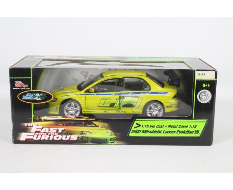 Racing Champions / Ertl - A boxed 1:18 scale 'Fast &amp; Furious' diecast 2002 Mitsubishi Lancer Evolution VII. Model appears