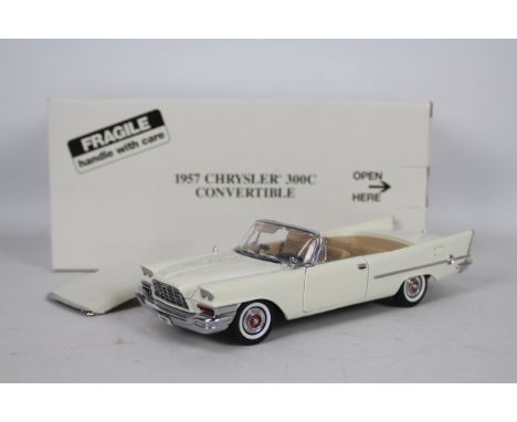 Danbury Mint - A boxed Danbury Mint diecast 1:24 scale 1957 Chrysler 300C Convertible. The model in cream appears to be in Go