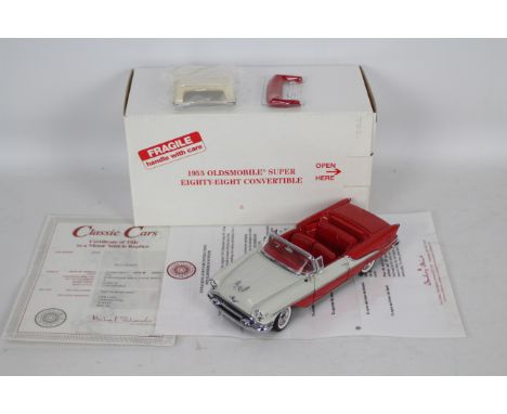Danbury Mint - A boxed Danbury Mint diecast 1:24 scale 1955 Oldsmobile Super Eighty-Eight Convertible. The model in red and w