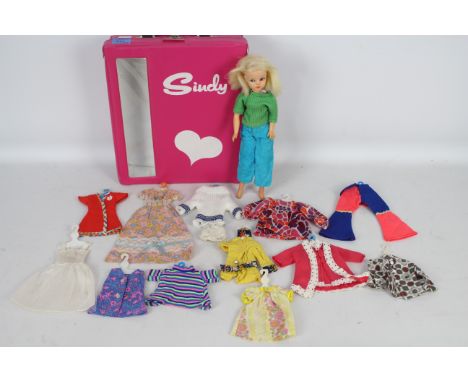 Sindy - A vintage Sindy carry case with doll and 12 x clothes hangers with outfits. This doll is a 1969 onwards Sindy Walker 