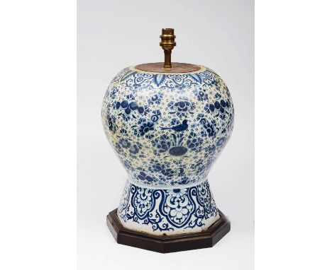 A DELFT BLUE AND WHITE TABLE LAMP of baluster form, painted with birds and flowering foliage (reduced), 41cm high overall