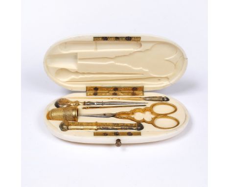 A FRENCH GILT METAL AND STEEL SEWING ETUI fitted scissors, needle case, thimble and three further tools within an oval ivory 