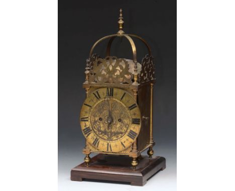 A 17TH CENTURY STYLE BRASS LANTERN CLOCK the engraved circular dial with Roman numerals and fusée mechanism striking on a gon