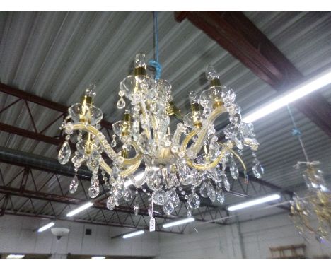 A MODERN GLASS EIGHT BRANCH CHANDELIER, with glass droppers, together with brass and glass ceiling light (2)