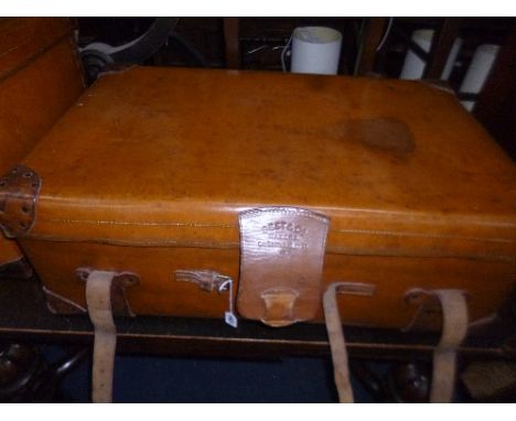 A TAN LEATHER STYLE TRAVELLING TRUNK, with leather handles and straps, stamped Best & Co, South Audley St, inititals to sides