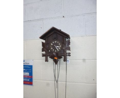 AN OAK CUCKOO CLOCK (two weights, loose parts)