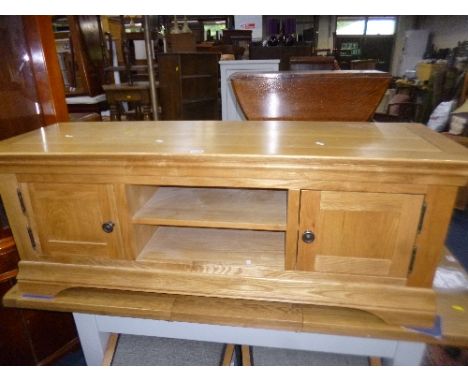 A LIGHT OAK TV CABINET/STAND, with double cupboard doors, approximate size width 134cm x depth 44cm x height 50.5cm