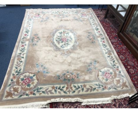 A CHINESE WOOLLEN CARPET SQUARE, brown, green and cream ground with a floral design and central lozenge, approximate size 380
