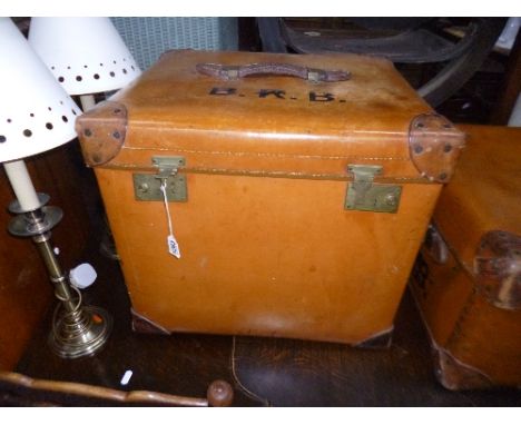A TAN LEATHER STYLE CUBED TRUNK, with a hinged top and leather handle, stamped Best & Co, South Audley St, lid mrked with ini