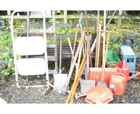 A WOODEN BENCH, a wooden step ladder, a metal step ladder and a quantity of garden tools
