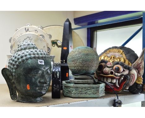 A PEWTER BUDDHA HEAD, approximate height 30cm, together with an Eastern wooden mask, garden planter, an obelisk and water fea