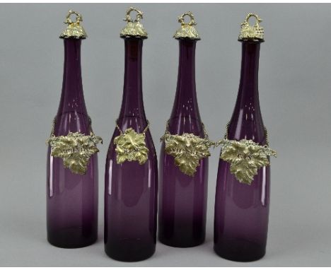 A SET OF FOUR AMETHYST COLOURED GLASS DECANTERS, with leaf shaped bottle labels, 'Rum', 'Whisky', 'Brandy' and 'Gin' (4)