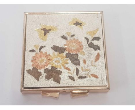 A DECORATIVE COMPACT