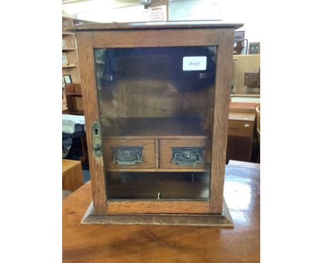 OAK SMOKERS CABINET WITH 2 DRAWERS, PIPE RACK &amp; HINGED GLASS FRONT