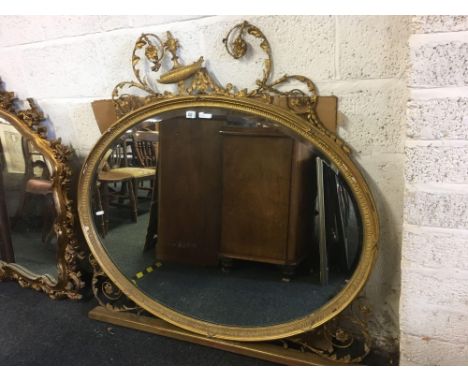 LARGE HEAVILY GILT FRAME OVAL OVER MANTLE MIRROR WITH SWAGS, NEEDS A BIT OF WORK
