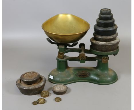 A set of vintage cast iron weighing scales by Frederick Hill & Co. with weights.