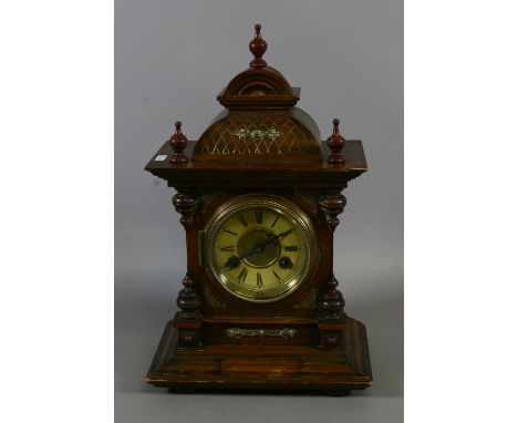 A German walnut cased eight day bracket clock housing an two train Junghams movement striking on a gong.