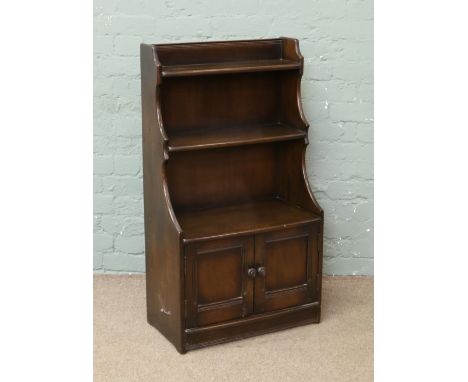 An Ercol two tier bookcase with double doors to base.