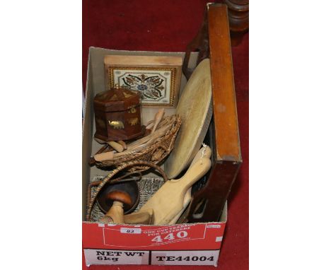 A box of various wooden items including butter patts, painted tray, chopping board, spoons, nut cracker, an Indian brass inla