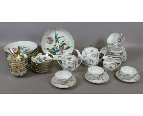 Two oriental tourist ware tea/dinner services, a tea service decorated with landscape scenes and a lithophane depicting a Gei