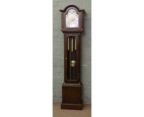 An oak cased eight day three train grandmother clock with arch top brass dial incorporating a moon roller, Westminster chimin