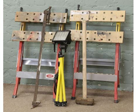 Two work mans benches, a sash cramp, sledge hammer and a halogen lamp on stand.