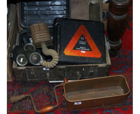 A military wooden box containing a quantity of tools to include compressor, battery drill, gas mask, hand drill etc.