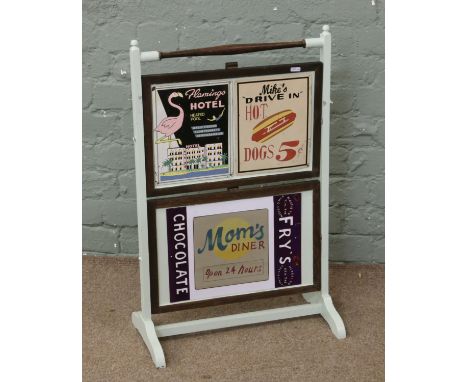 A part painted metamorphic dumb  waiter/firescreen decorated with tin plate advertising signs.