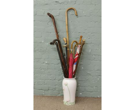 A ceramic stick stand and contents of sticks, canes, shooting stick, shepherds crook, umbrellas etc.