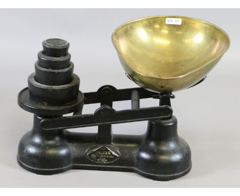 A pair of black painted Salter scales with brass bowl and iron weights.