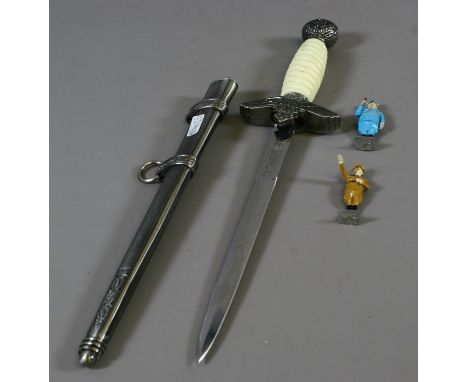 A reproduction third Reich officers dagger, along with two painted lead figures one of Goebels the other Hitler.