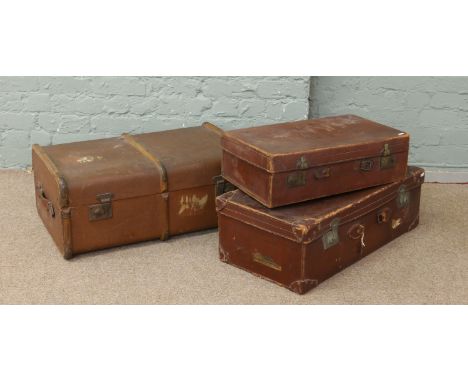 A vintage wood bound steamer trunk along with two vintage leather suitcases (AF).