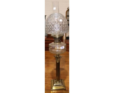 A Victorian brass oil lamp with Corinthian column, glass reservoir and shade 