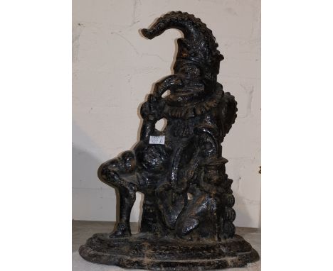 A painted mirror firescreen in brass frame; a Punch cast iron doorstop 