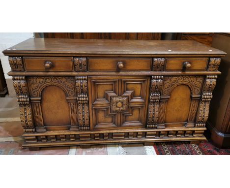 A period style carved oak sideboard of 3 cupboards and 3 drawers by Titchmarsh &amp; Goodwin 