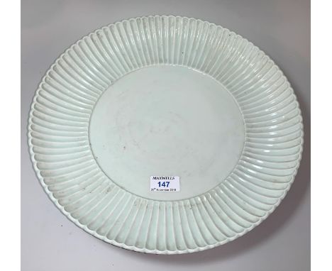 A large Chinese 'Qing' white glazed shallow dish with raised fluted border, underglaze blue seal mark to base, diameter 35cm 