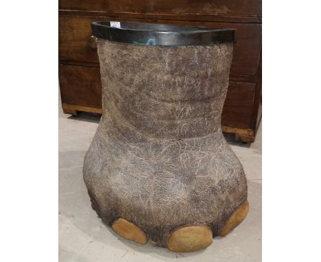 A vintage elephant's foot stick stand with brass lining
