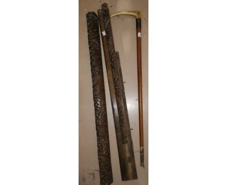 A Malacca cane with antler handle; an African hardwood stick with carved spiral shaft; 2 antique carved oak furniture mounts 