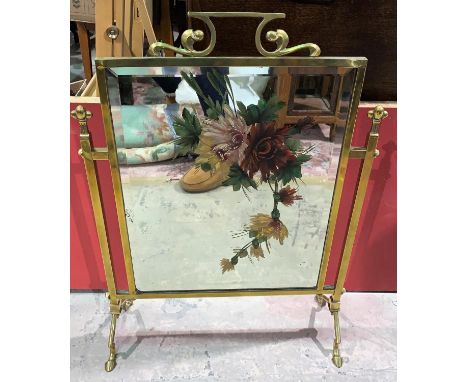 An Art Nouveau painted mirror firescreen in brass frame 