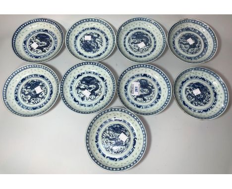 A Chinese set of 9 porcelain saucers decorated in underglaze blue with dragons, 14.5 cm